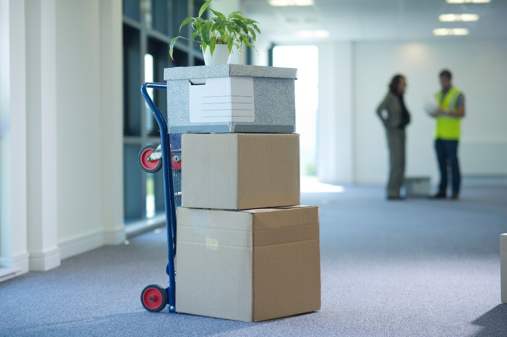 Boxes on a dolly being moved into a building in Houston