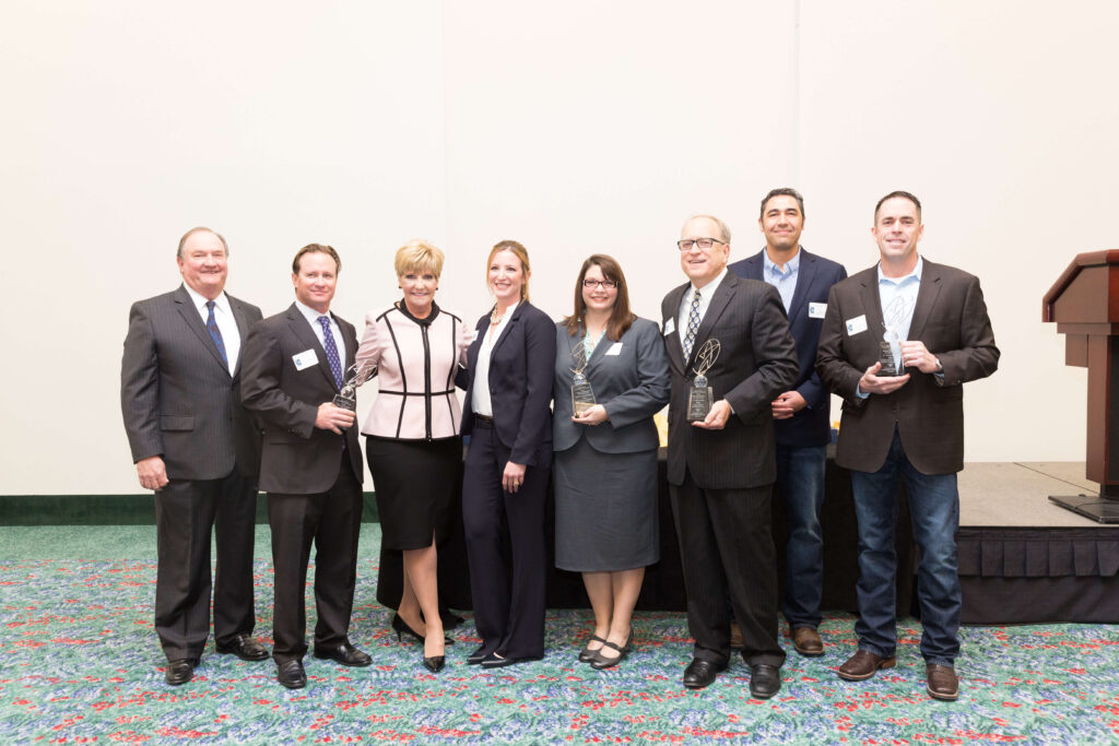Company posing with organization after accepting an award