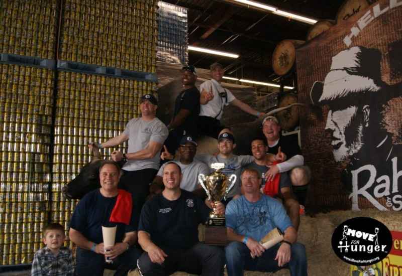 Team holding trophy at Move for Hunger event